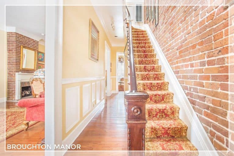 Staircase, hallway and peak of living room of Broughton Street Manor vacation rental in Savannah, Georgia